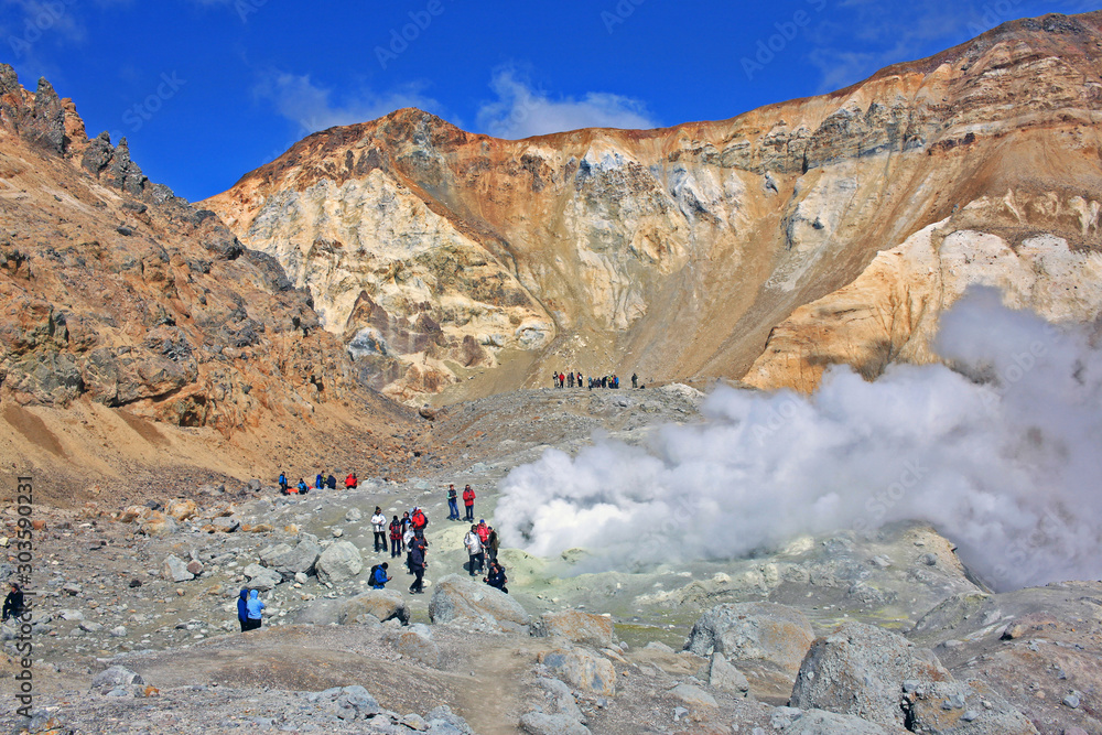 Tourists in the crater of Mutnovsky volcano. Russia