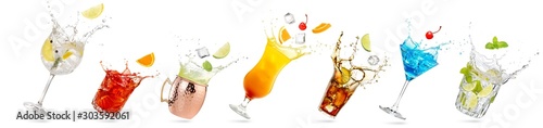 collection of tilted glasses with splashing cocktails isolated on white photo