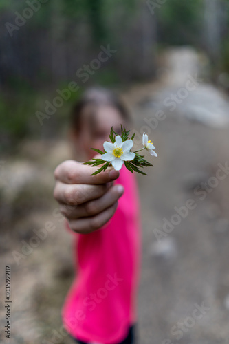 Girl holding up some flowers