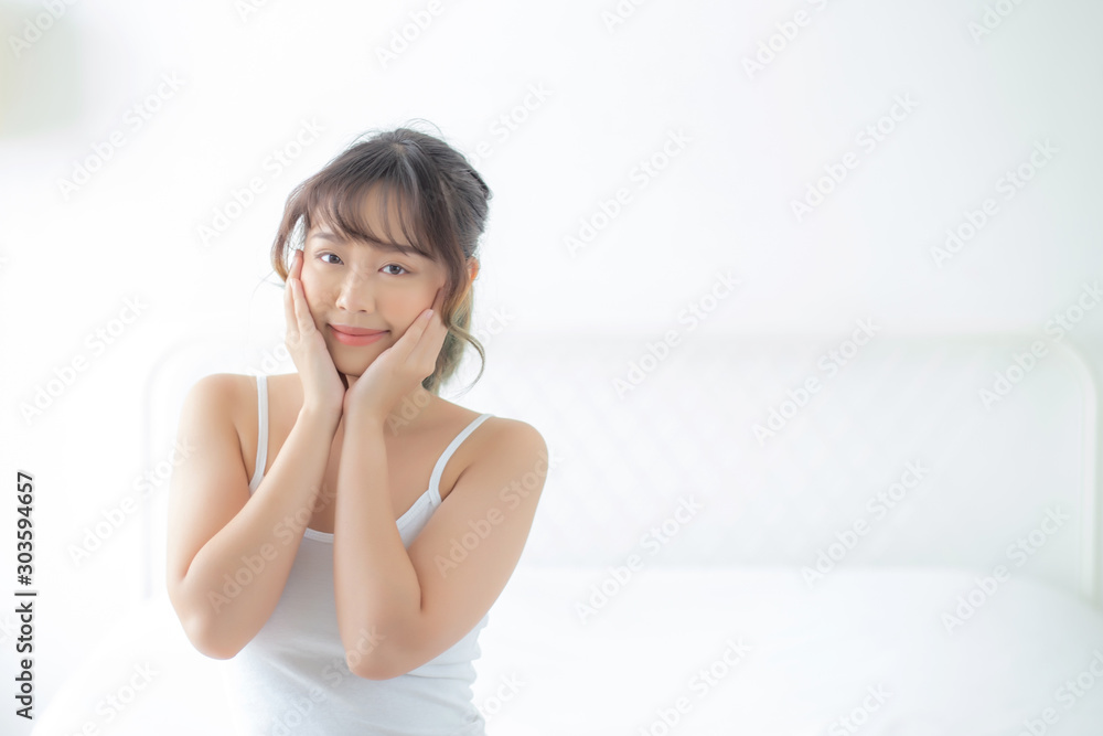 Portrait of beautiful young asian woman smile while wake up healthy and wellness with sunrise at morning in the bedroom, asia girl skin care with happy with fresh, lifestyle and relax concept. Portrait of beautiful young asian woman smile while wake up healthy and wellness with sunrise at morning in the bedroom, asia girl skin care with happy with fresh, lifestyle and relax concept.