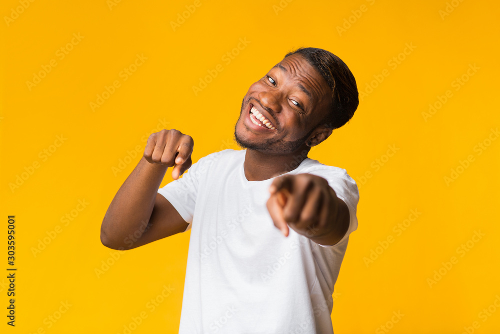 Smiling Black Guy Pointing Fingers At Camera Standing, Yellow Background Smiling Black Guy Pointing Fingers At Camera Standing, Yellow Background