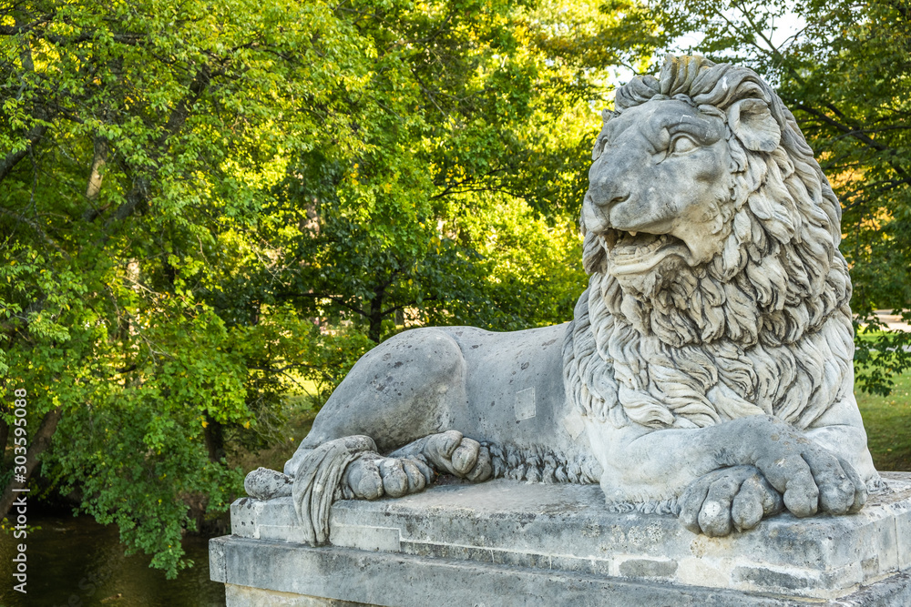 View of lion statute at Laxenburg castles park in the evening, the castles became a Habsburg possession in 1333 and formerly served as a summer retreat, at Laxenburg, Lower Austria, Austria. View of lion statute at Laxenburg castles park in the evening, the castles became a Habsburg possession in 1333 and formerly served as a summer retreat, at Laxenburg, Lower Austria, Austria.