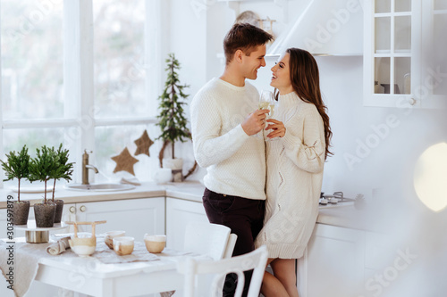 affectionate couple hugging in kitchen and looking at each other