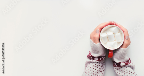 Woman in creative sweater drinking chocolate mug