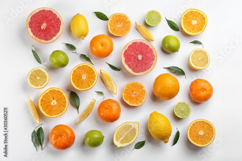 Flat lay composition with tangerines and different citrus fruits on white background