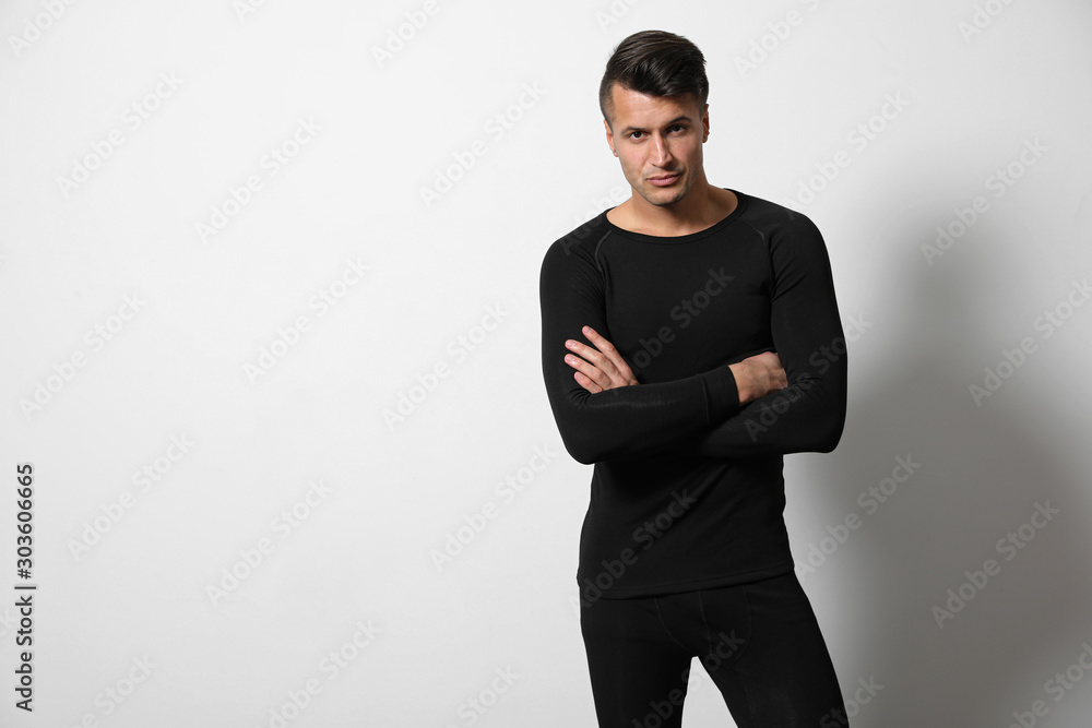 Man wearing thermal underwear on light grey background. Space for text Man wearing thermal underwear on light grey background. Space for text