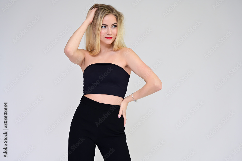 Glamorous cosmetics concept. Portrait of a fashionable beautiful blonde model on a white background with long hair, excellent makeup, beautiful face and lips on. Glamorous cosmetics concept. Portrait of a fashionable beautiful blonde model on a white background with long hair, excellent makeup, beautiful face and lips on.