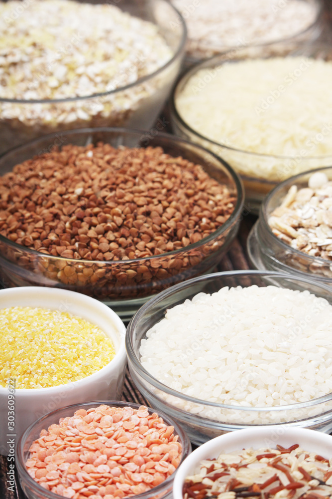 A set of bowls filled with different seeds: buckwheat, rise, corn and oatmeal A set of bowls filled with different seeds: buckwheat, rise, corn and oatmeal