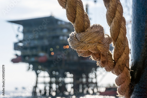 Knotted rope on board a contruction work bare at oil filed near an oil production platform photo