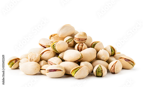 Pile of pistachios in the peel close-up on a white background. Isolated. photo