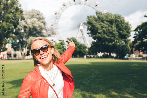 Photos Young woman in the Prater area on the background of the Vienna Ferris Wheel