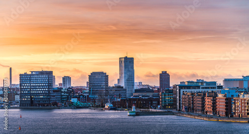 Malmo city in Sweden, with high-rise buildings and hotels close to the water with a colorful sunrise in the background