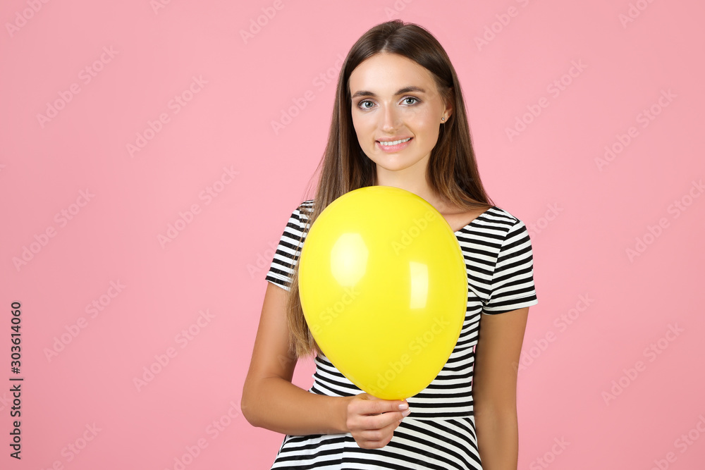 Young woman with balloon on pink background Young woman with balloon on pink background