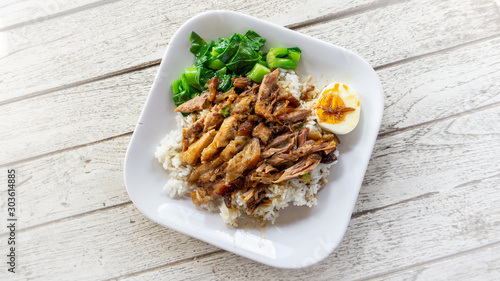 Thai stewed pork and boiled egg topped on rice.