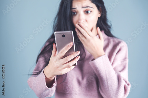 surprised woman hand holding phone