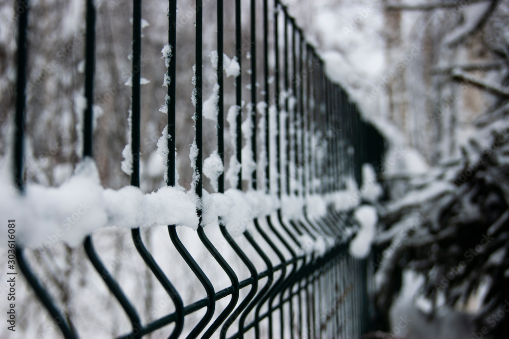 Snow-covered element of the old fence. The winter passed and the snow remained. Snow-covered element of the old fence. The winter passed and the snow remained.