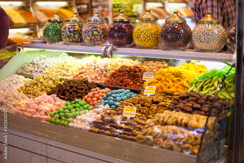 delicious street food and deserts. Traditional oriental sweet Turkish desert in display at a street food market. Colorful image of various sweets  candied fruit jelly at market stall
