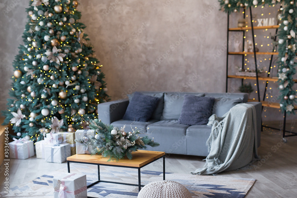 Interior of modern living room with comfortable sofa decorated with Christmas tree and gifts - obrazy, fototapety, plakaty 