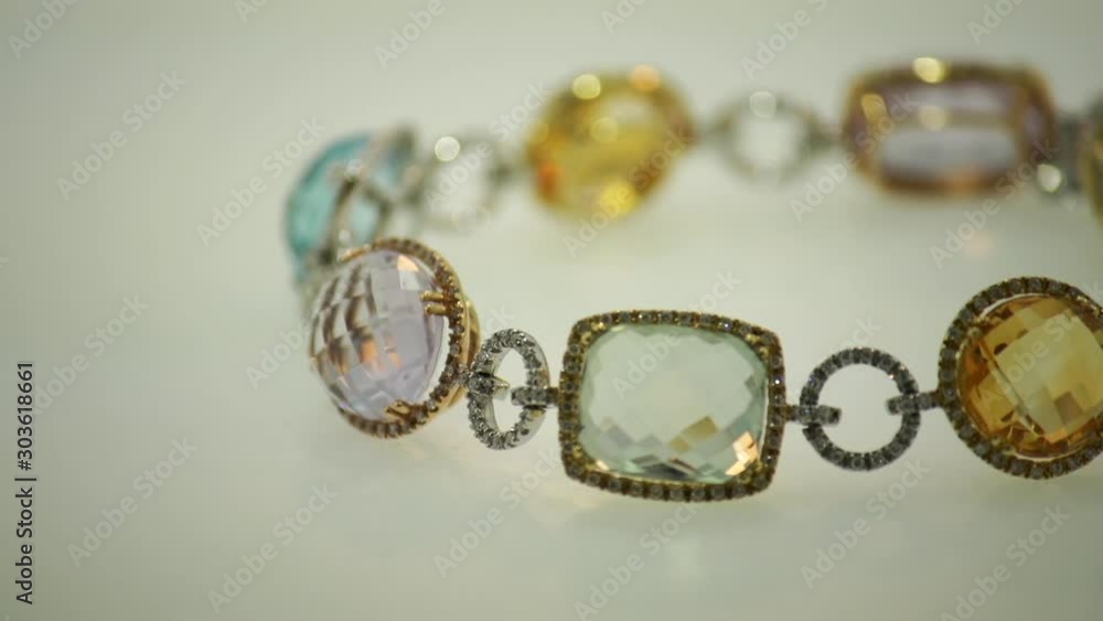 Jewelry on a white rotating surface, a beautiful bracelet. Jewelry on a white rotating surface, a beautiful bracelet.