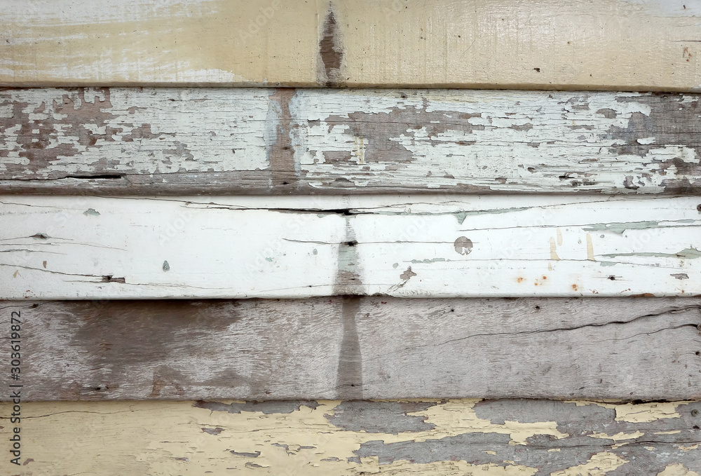Fototapeta premium damaged wood panel siding house, grunge wooden plank peeling paint surface and crack, close up rustic outside barn wall weathered