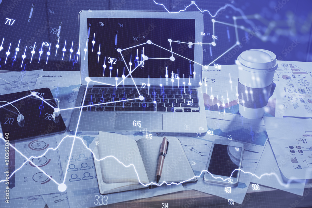 Financial chart drawing and table with computer on background. Multi exposure. Concept of international markets. Financial chart drawing and table with computer on background. Multi exposure. Concept of international markets.