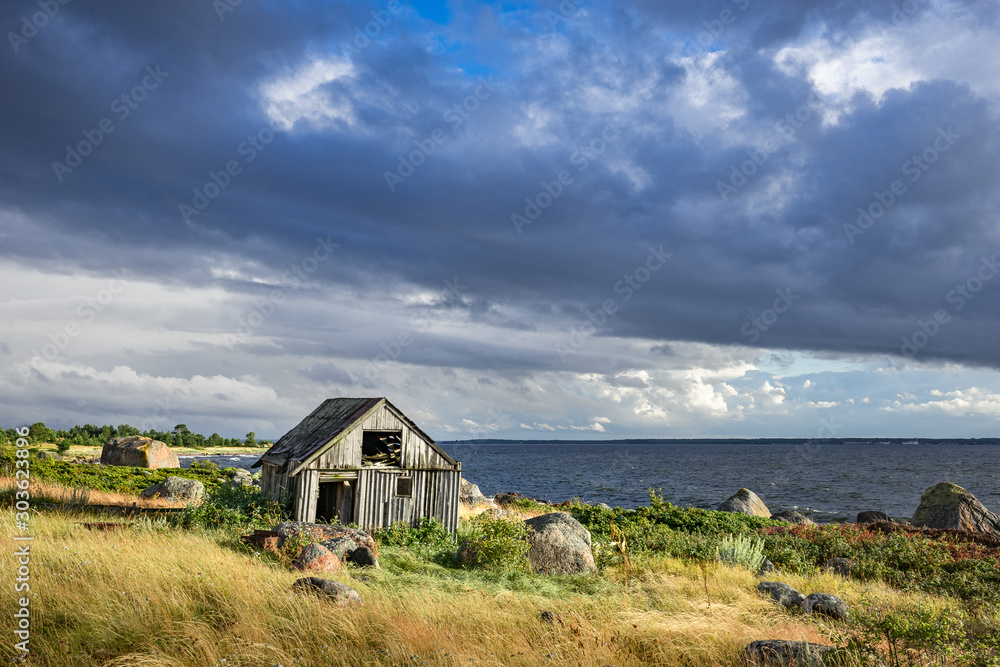 Abandoned houses in the Baltic Sea. Shore, nature and ruins facilities architecture concept. Mohni, small island in Estonia, Europe. Abandoned houses in the Baltic Sea. Shore, nature and ruins facilities architecture concept. Mohni, small island in Estonia, Europe.