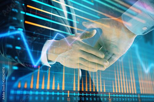 Multi exposure of forex graph on abstract background with two businessmen handshake. Concept of success on stock market