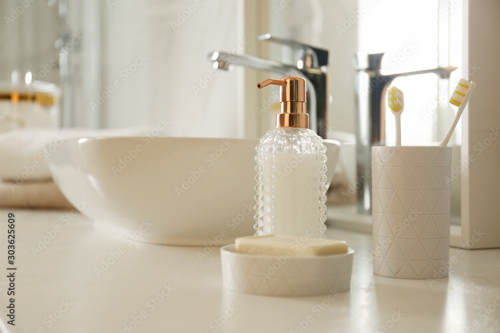 Toiletries near vessel sink in modern bathroom Toiletries near vessel sink in modern bathroom