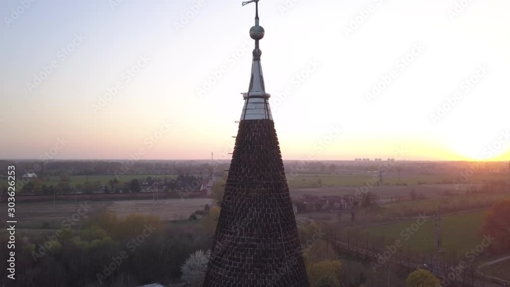 Scenic 4k aerial drone lowering footage at sunset time to the summit of Chiaravalle abbey, ancien and prestigious italian monument in the south of Milan. .
