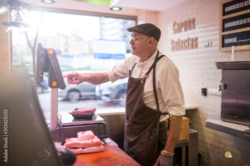 butcher serving at his butcher shop