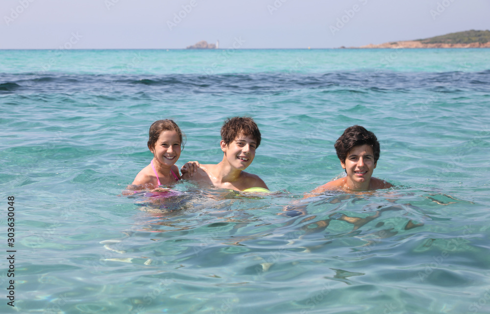 two young brothers and their younger sister in the clean sea
