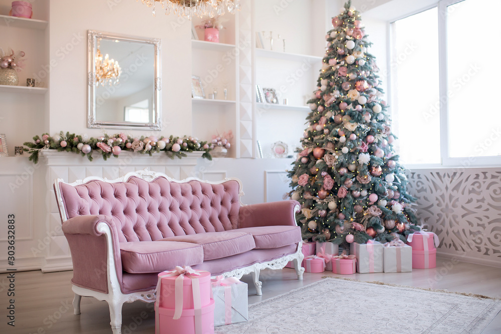 Interior of bright modern living room with fireplace and comfortable sofa decorated with Christmas tree and gifts Interior of bright modern living room with fireplace and comfortable sofa decorated with Christmas tree and gifts
