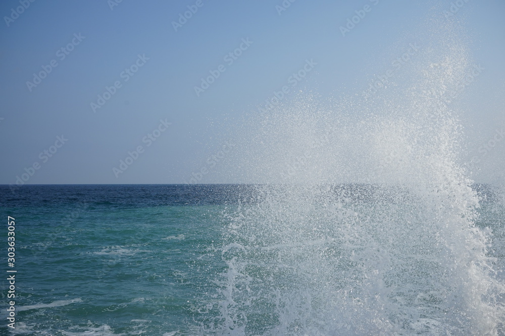 Splashing waves in a storm at sea on a clear day