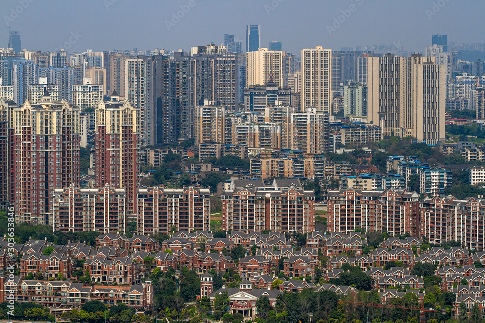 Chongqing, China - March 20, 2018:  Top view of the  huge Chinese city of Chongqing. Sunny day in modern metropolis.