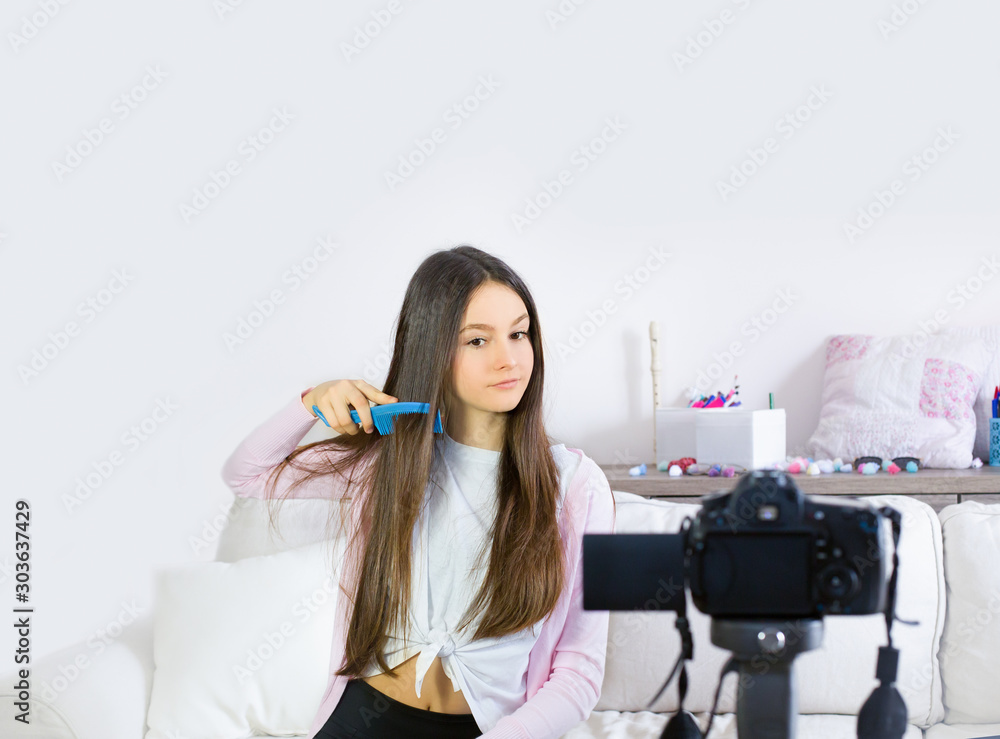 Two teen girls blogger presents beauty products and transmitting live video to social networks. Focus on the influencer of teenage blogger girls. Beauty blogger and vlog concept. Two teen girls blogger presents beauty products and transmitting live video to social networks. Focus on the influencer of teenage blogger girls. Beauty blogger and vlog concept.