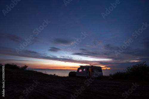 camping, mobile home on the beach, green grass, twilight