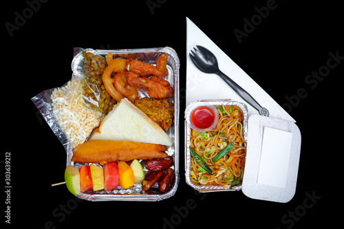 The Food Warmer Aluminum Foil Rectangular Disposable Parcel box. Ramadan iftar Take away delivery. 450ML Foil Container iftar food boxes. Top view, flat lay at white and Black background. photo