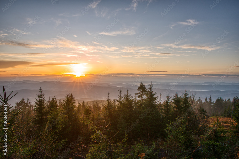 Gorgeous sunrise with fog in the mountains with trees in the foreground, Czech, Lysa Mountain