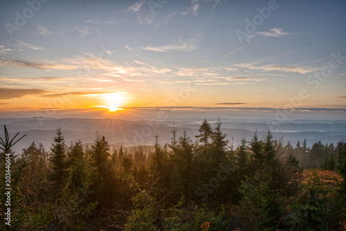 Gorgeous sunrise with fog in the mountains with trees in the foreground  Czech  Lysa Mountain
