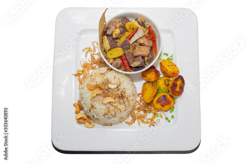 A plate of home chef Beef Kata Masala, plane flavourful nutty pulao and little poteto fried. Top view. on white background. photo