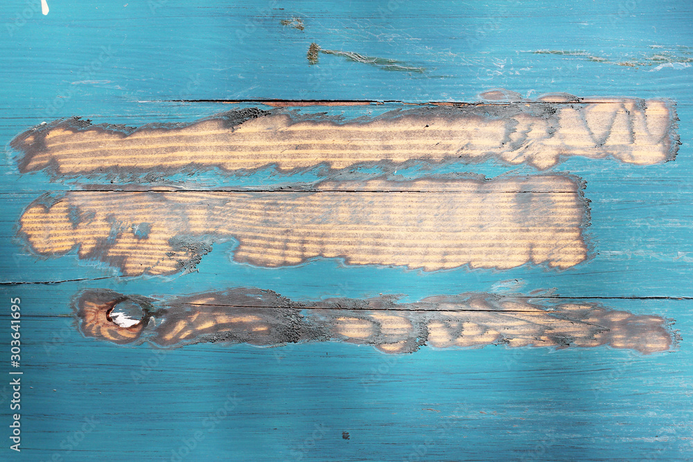 the texture of peeling blue paint on a wooden fence