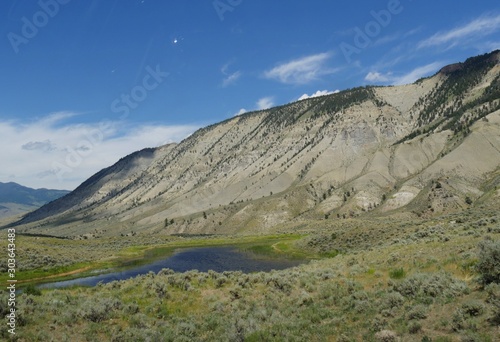 Rolling hills and lush valleys, with the Yellowstone River flowing along at Yellowstone National Park.