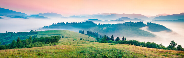 Foggy morning panorama of mountains valley. Splendid summer sunrise in Carpathian mountains, Rika village location, Transcarpathian, Ukraine, Europe. Beauty of nature concept background.