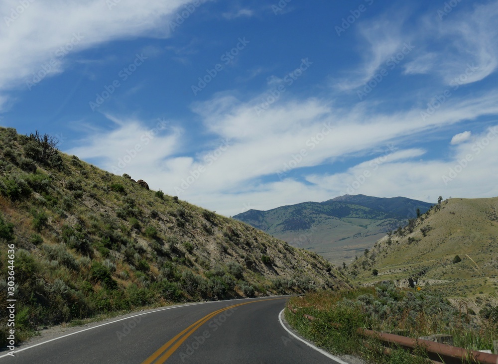 Scenic winding road at Yellowstone National Park on a beautiful day near the Gardiner exit in Montana. Scenic winding road at Yellowstone National Park on a beautiful day near the Gardiner exit in Montana.