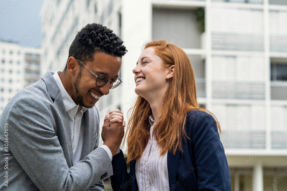 Smiling couple holding hands while standing outdoors Smiling couple holding hands while standing outdoors