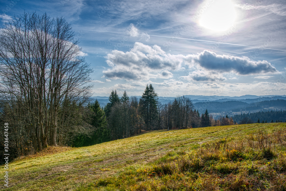 meadow with road and village in the mountains in autumn meadow with road and village in the mountains in autumn