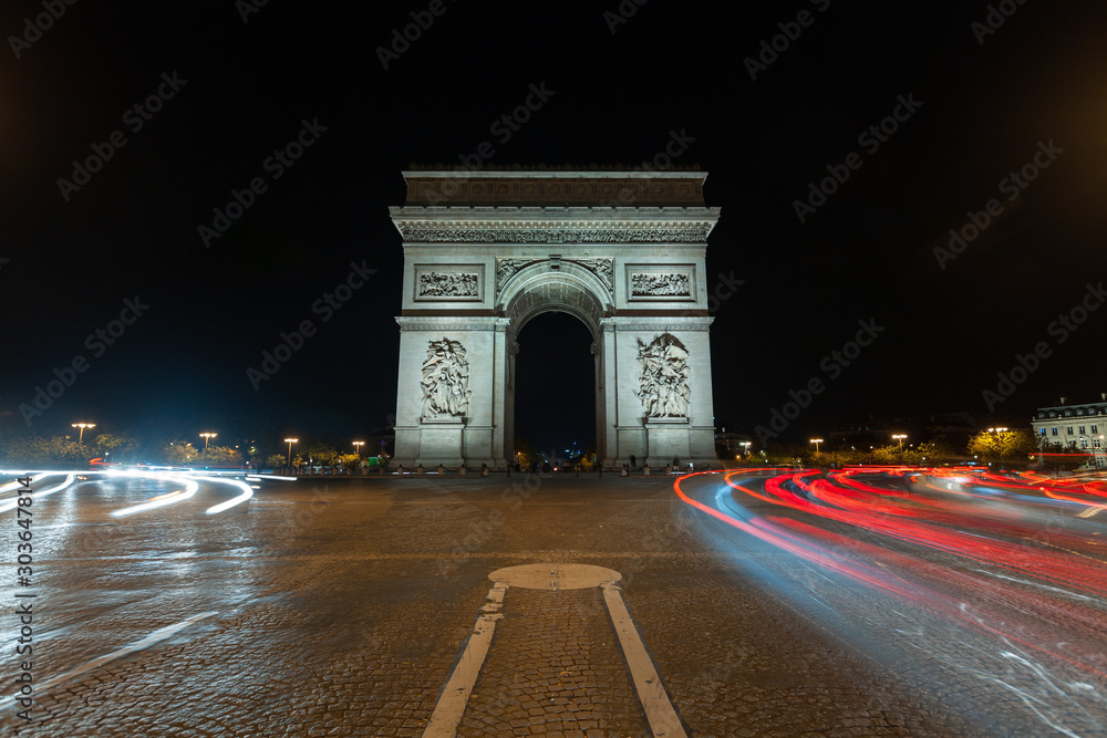 Traffic light trails in front of the Arc de Triomphe at night, Paris, France Traffic light trails in front of the Arc de Triomphe at night, Paris, France