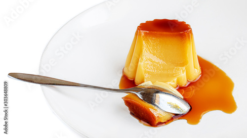Cream  caramel, flan, or caramel pudding with sweet syrup  on a plate  isolated on white background. Homemade custard photo