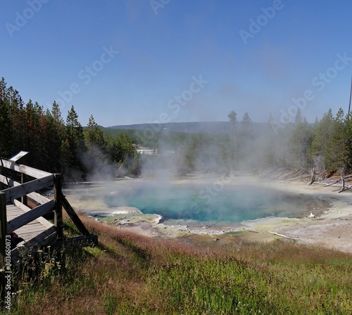 View from the woden deck of the Emerald Spring with hot steam rising off at the Norris Geyser Basin at Yellowstone National Park, Wyoming.