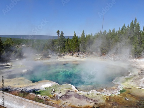Breathtaking boiling Emerald Spring with hot steam rising off at the Norris Geyser Basin at Yellowstone National Park, Wyoming.